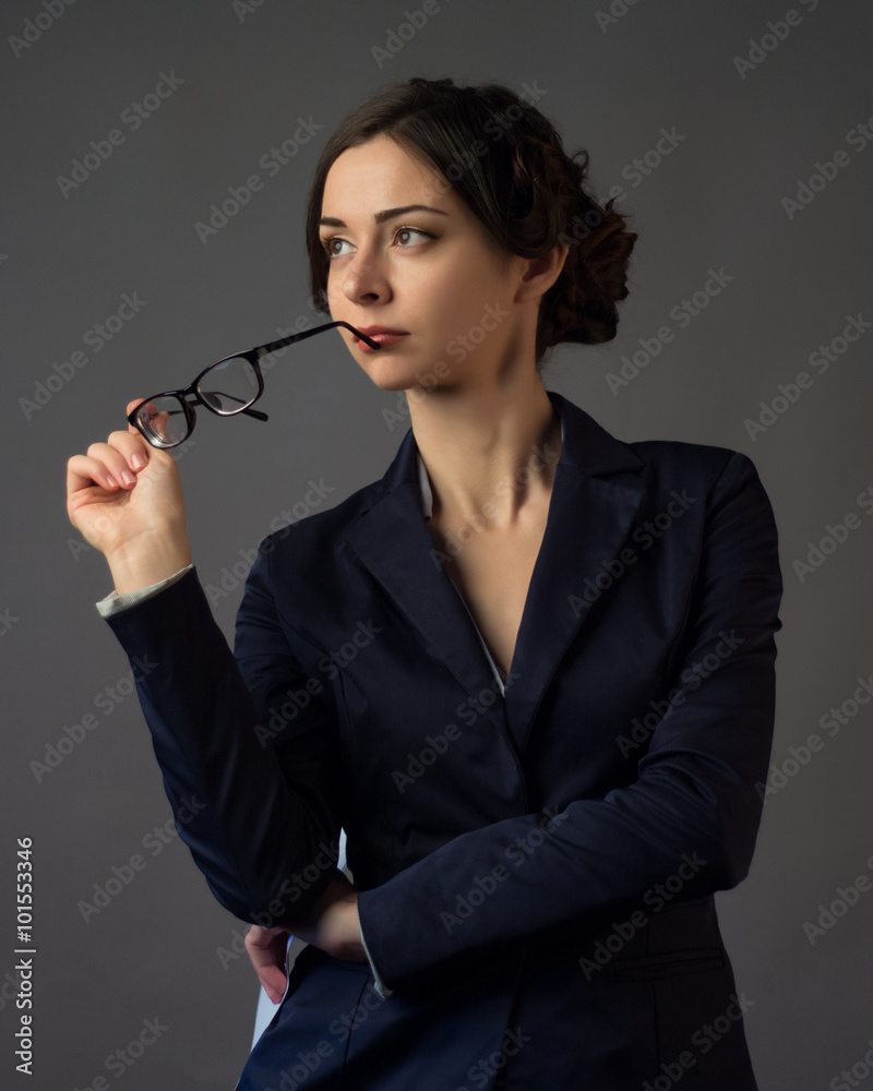 Thoughtful businesswoman on a gray background Thoughtful businesswoman on a gray background