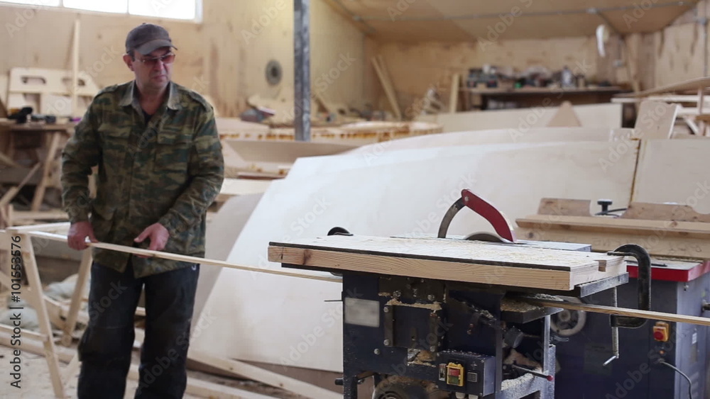 Carpenter working with circular saw woodworking machine in a carpentry workshop
Carpenter working with circular saw woodworking machine in a carpentry workshop