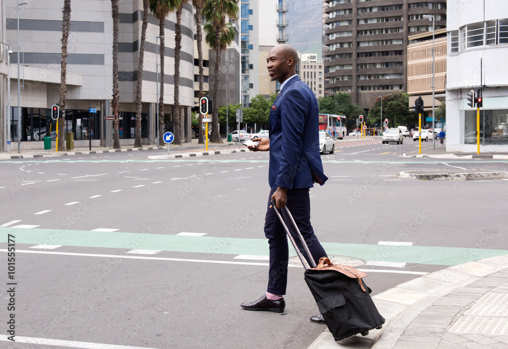 Business man walking with pull bag in the city
