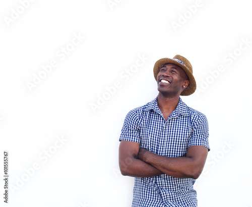 Smiling african american guy with arms crossed looking away