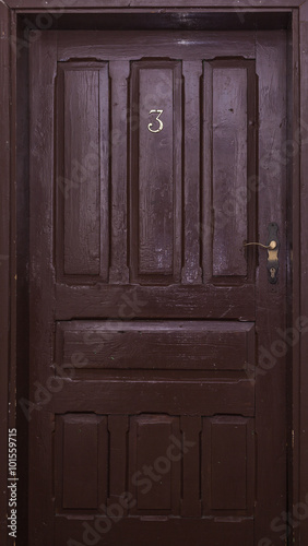 Number three wooden door in an ancient hotel