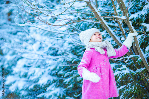 Little adorable girl with in winter day outdoors