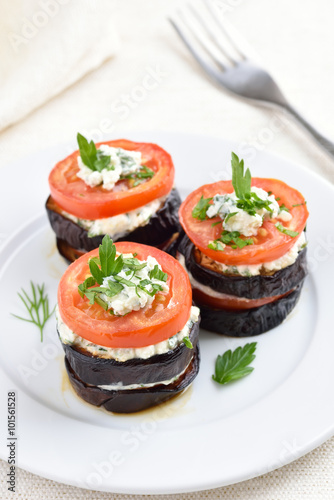 Appetizer eggplant with tomatoes, curd cheese and herbs