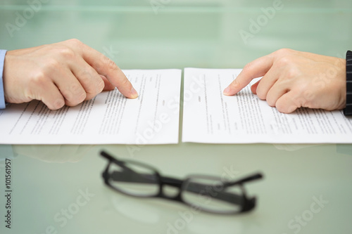 man and wife are reading divorce agreement