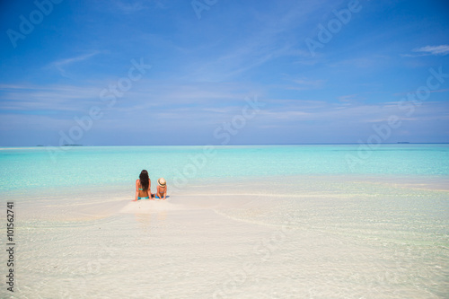 Mother and daughter enjoying time at tropical beach © travnikovstudio