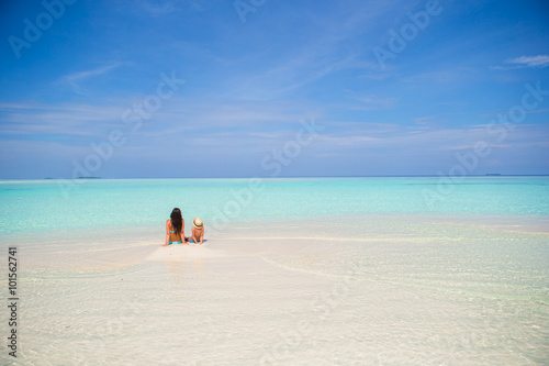 Mother and daughter enjoying time at tropical beach