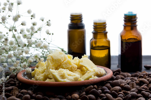 natural organic soap bottles essential oil and sea salt on a wooden table coffee background