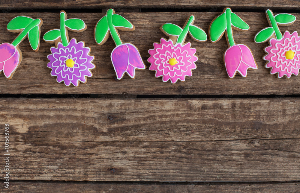 Homemade gingerbread cookies in the shape of flowers on wooden table Homemade gingerbread cookies in the shape of flowers on wooden table