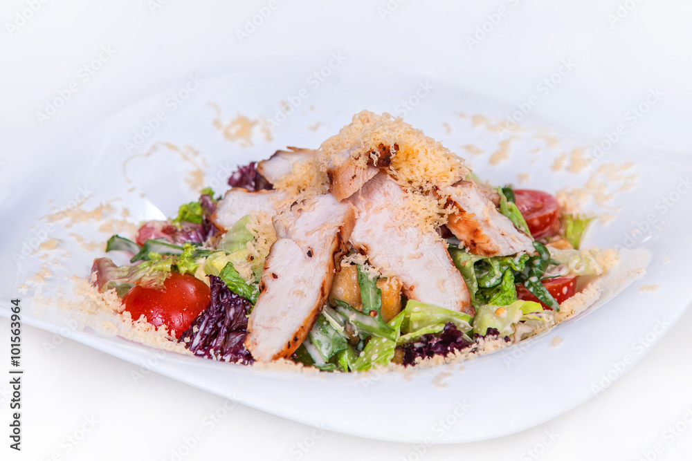 Caesar salad with croutons, lettuce, arugula, cherry tomatoes and grilled chicken. Isolated dish on a white background Caesar salad with croutons, lettuce, arugula, cherry tomatoes and grilled chicken. Isolated dish on a white background