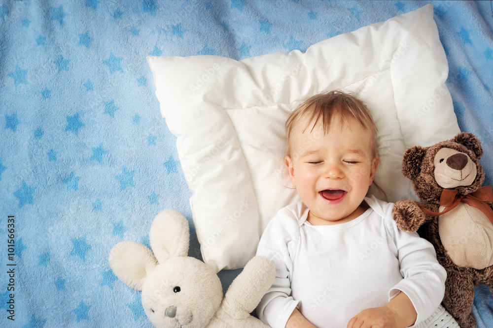 One year old baby with alarm clock One year old baby with alarm clock