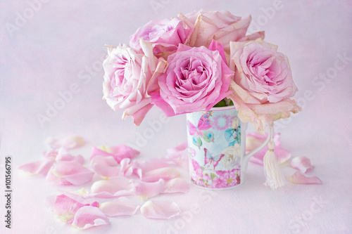 Beautiful fresh pink roses in a beautiful box on a light background .