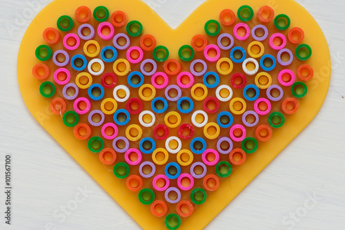 Heart made from tiny colorful rings photo