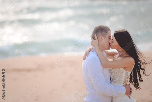 Romantic kissing loving couple on the beach