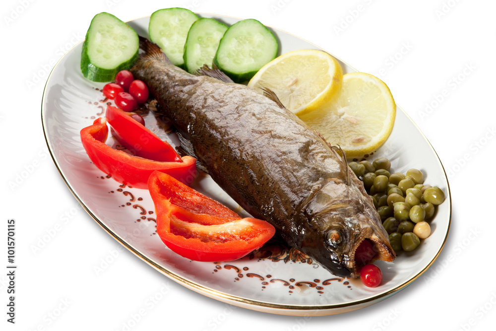 Baked trout with vegetables on the plate on a white background Baked trout with vegetables on the plate on a white background