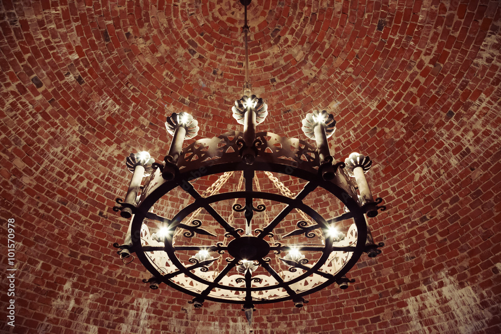 Fototapeta premium Retro chandelier hanging in the brick ceiling