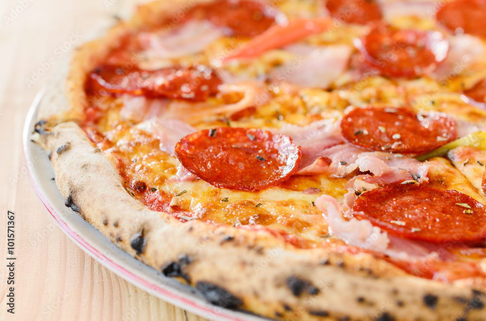 Pizza with sausage, bacon and pepperoni - close up Pizza with sausage, bacon and pepperoni - close up