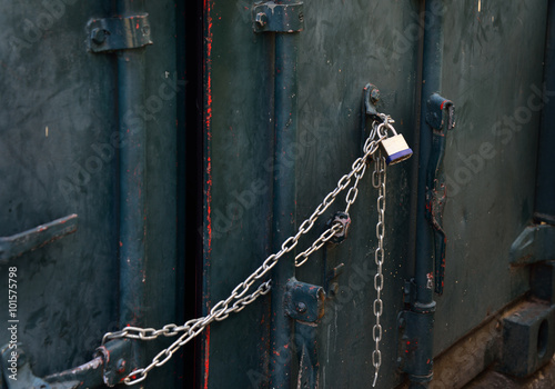Closeup of a metal gate chained and locked