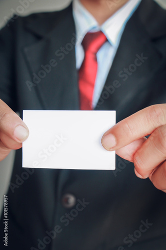 Close up of business man holding white blank card