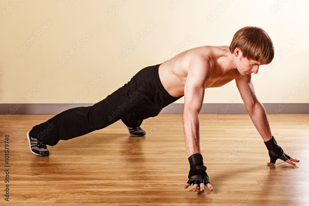 Man is standing in emphasis lying on his outstretched hands.