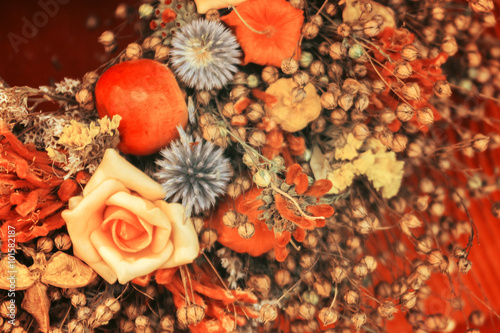 Arrangement of roses  dried leaves  apples at the tissue background