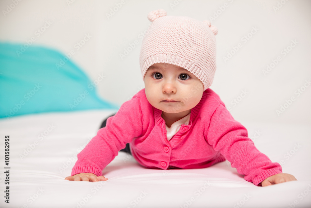 Cute baby girl lying on a bed Cute baby girl lying on a bed