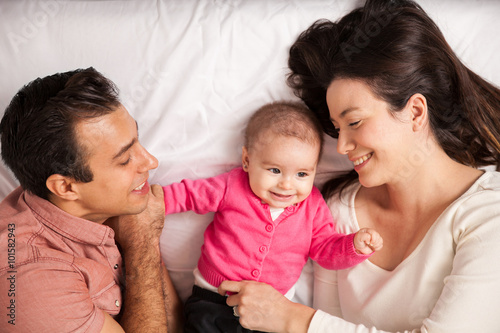 Parents and baby in a bed