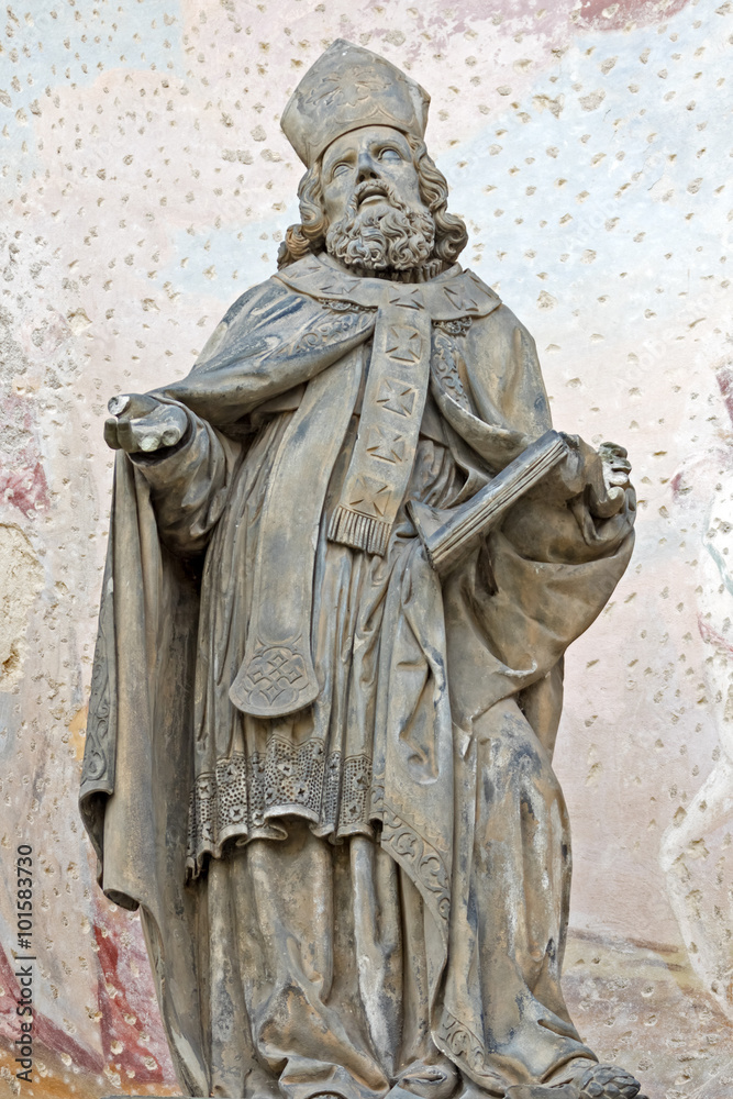 A metal figure of a priest