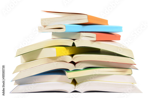 Untidy small pile heap of paperback books some open closed isolated on white background photo