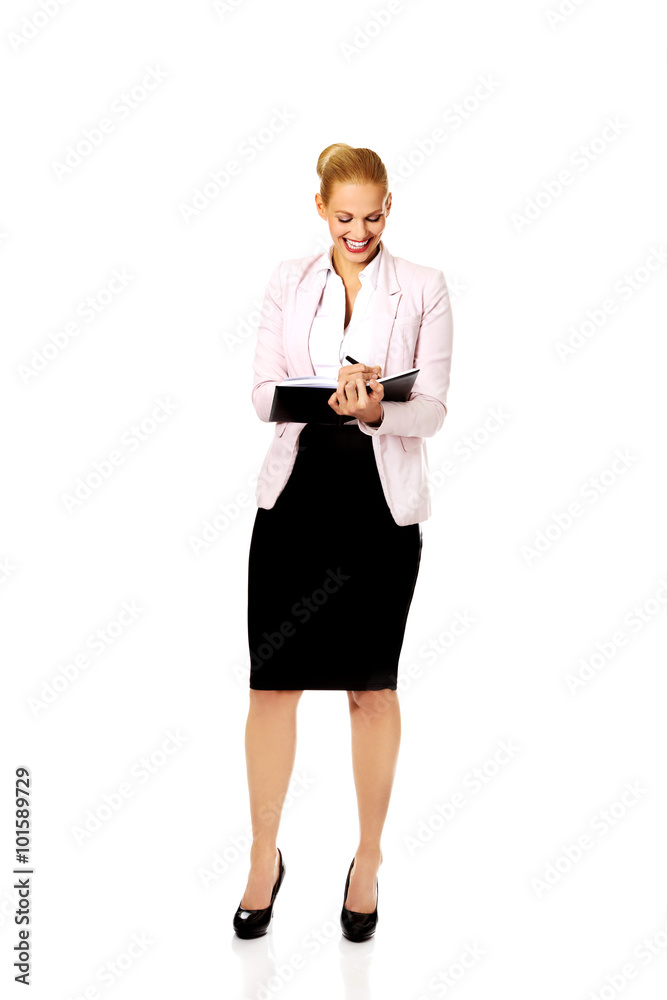 Young smile business woman making a notes Young smile business woman making a notes