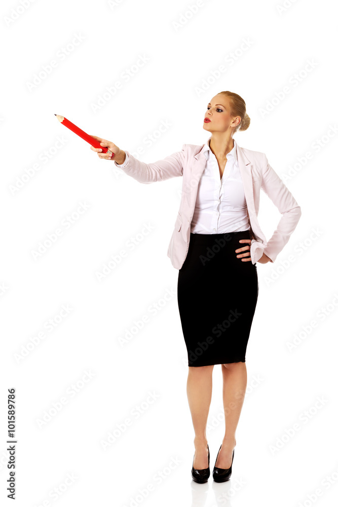 Business woman pointing for copyspace or something with huge pen Business woman pointing for copyspace or something with huge pen