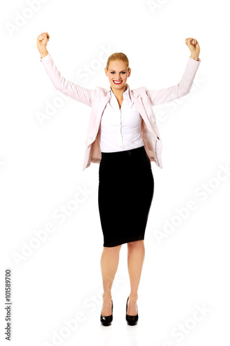 Young happy business woman with arms up