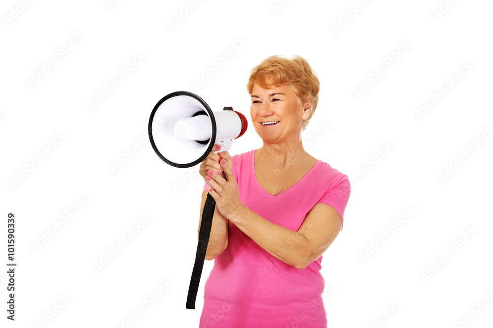 Senior smiling woman screaming through a megaphone Senior smiling woman screaming through a megaphone