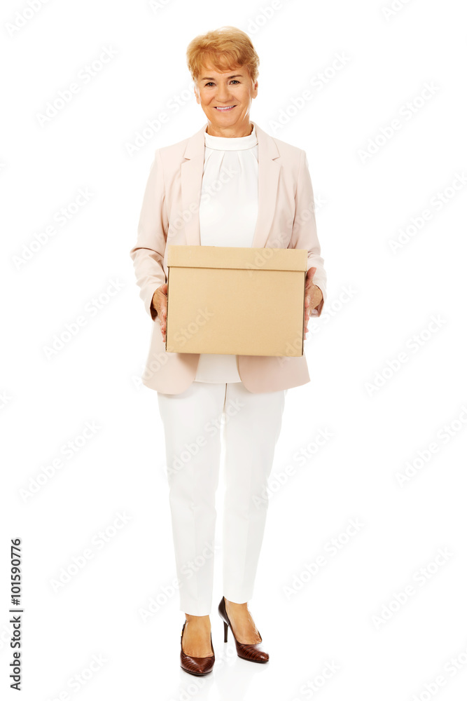 Smile elderly business woman holding cardboard box Smile elderly business woman holding cardboard box