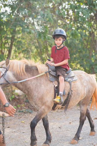 Little boy riding training horse © wckiw