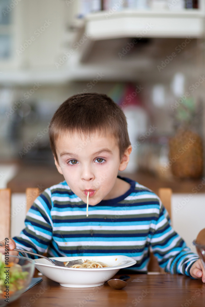 Cute little boy, eating spaghetti at home for lunchtime Cute little boy, eating spaghetti at home for lunchtime