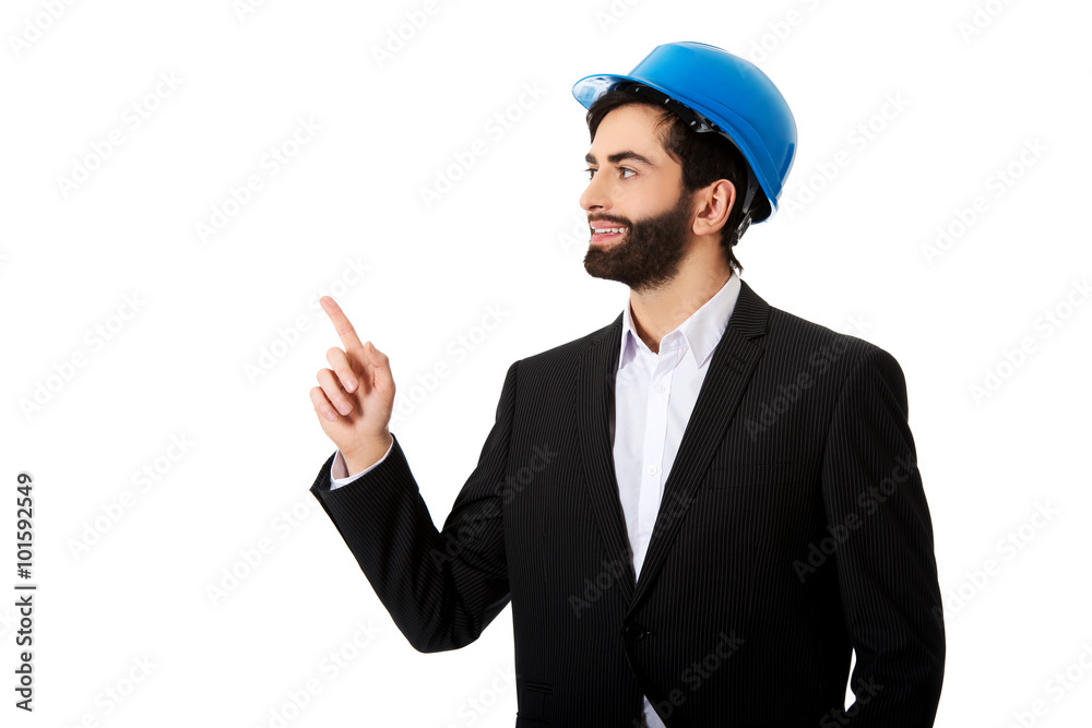 Engineer in protective helmet pointing up. Engineer in protective helmet pointing up.