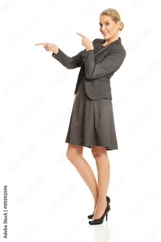 Business woman pointing at copyspace on the left Business woman pointing at copyspace on the left
