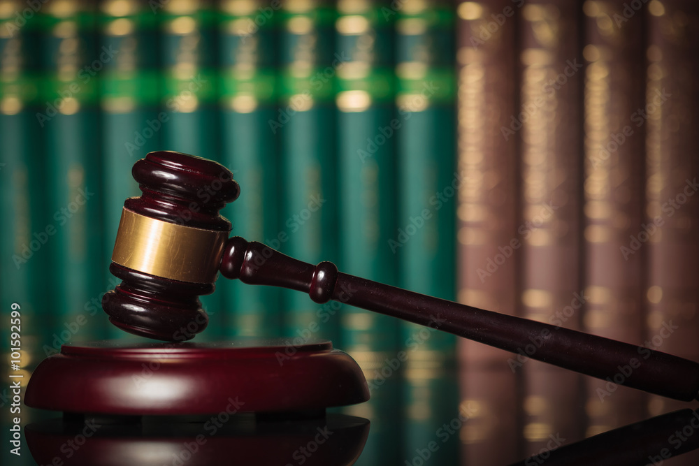 Fotografie side of  judge's gavel in front of law books