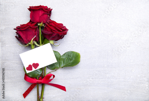 beautiful red rose on wooden background with card for valentine day and space for text