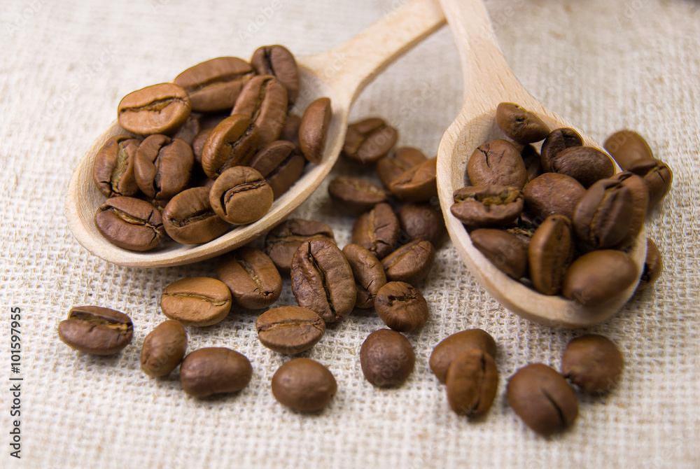 Many roasted coffee beans in the spoons Many roasted coffee beans in the spoons
