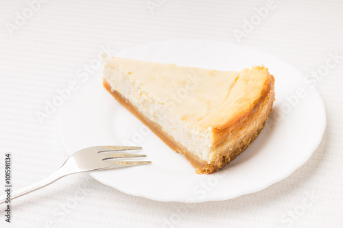 Piece of cheesecake on white saucer
