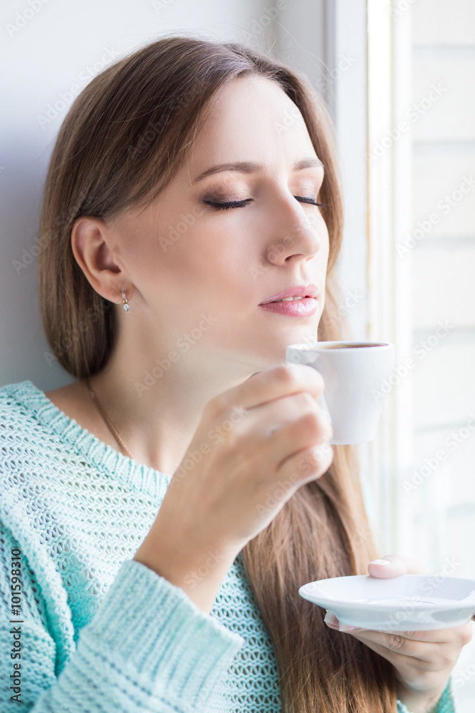 Young beautiful woman enjoying cup of espresso Young beautiful woman enjoying cup of espresso