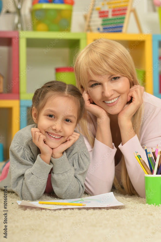 Fototapeta premium Girl painting with mother