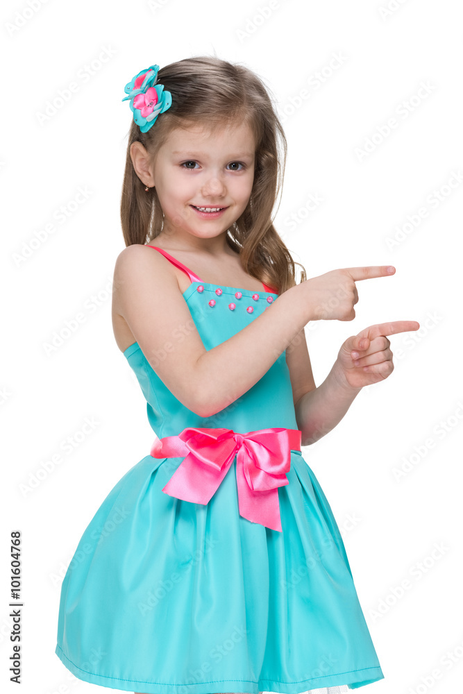 Smiling little girl shows her fingers to the side Smiling little girl shows her fingers to the side