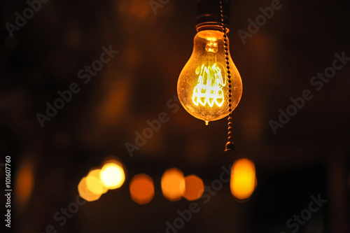 Glowing Edison's light bulbs on the dark background. © diter