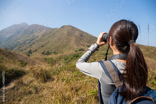 Back view of woman looking through binoculars