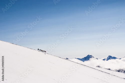 Climbing climbers on the snowy mountain top. line dreams
