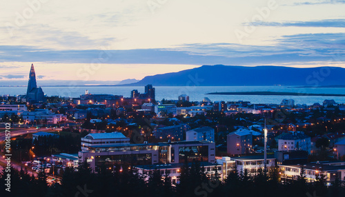 Beautiful super wide-angle aerial view of Reykjavik, Iceland with harbor and skyline mountains and scenery beyond the city, seen from the observation tower of Hallgrimskirkja Cathedral. photo