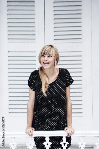 Smiling young woman on balcony