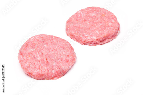 Raw crocodile meat burgers isolated on a white studio background